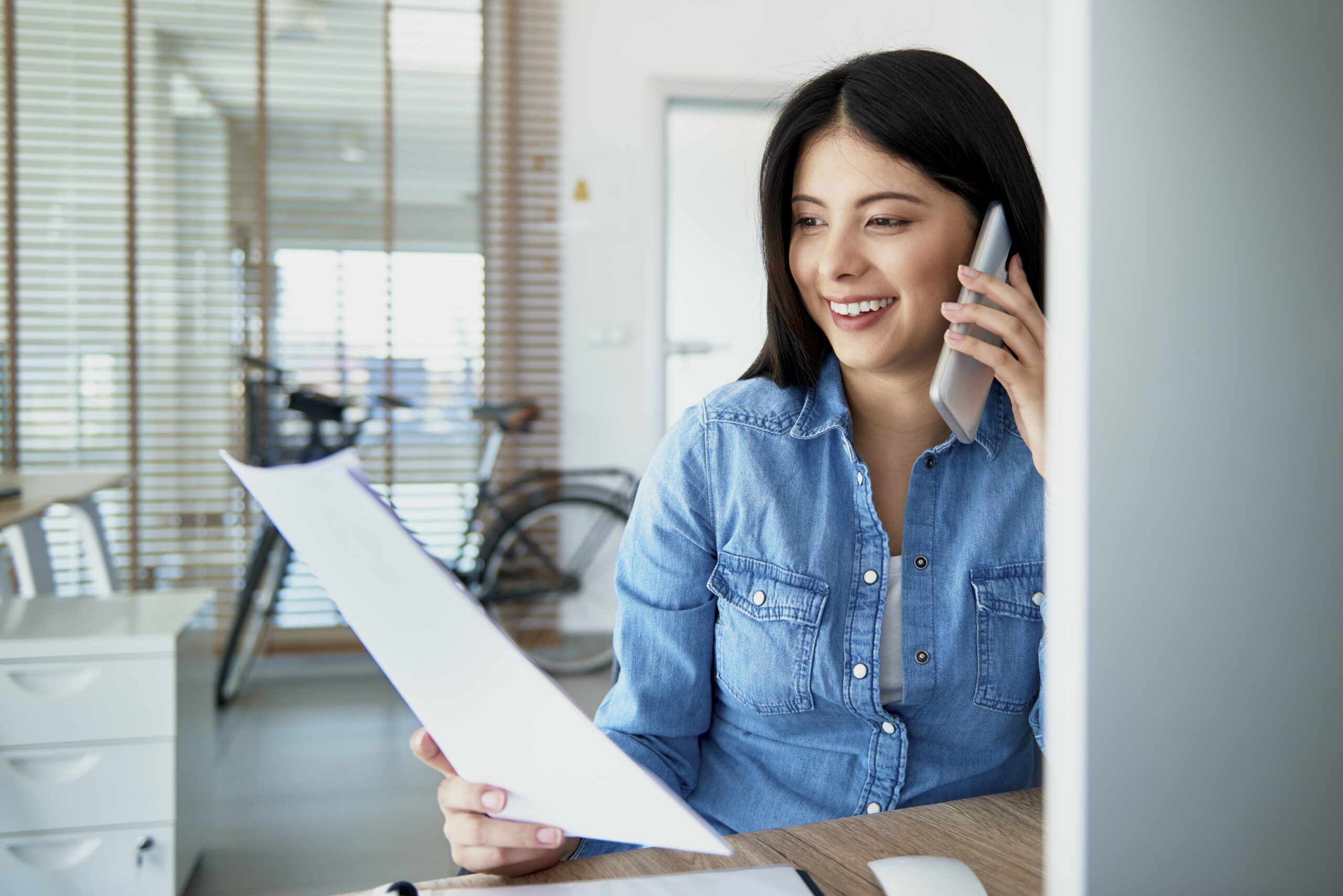 cheerful asian woman in the office talking on the 2022 02 02 04 49 57 utc min